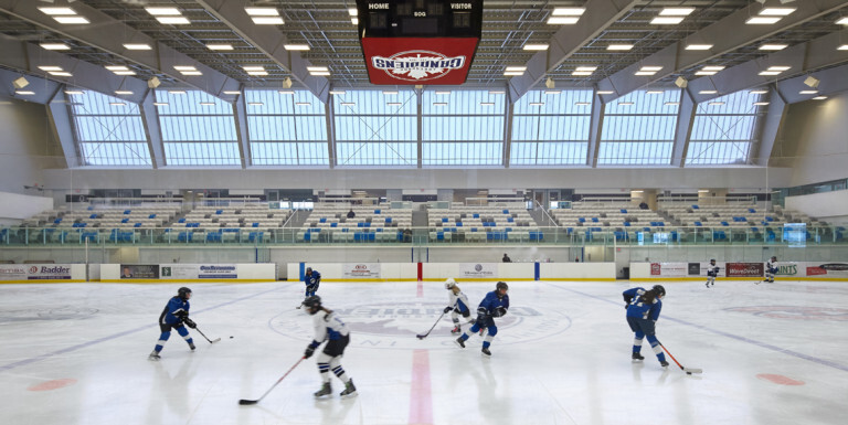 Two hockey teams playing against each other within the Atlas Tube Centre.