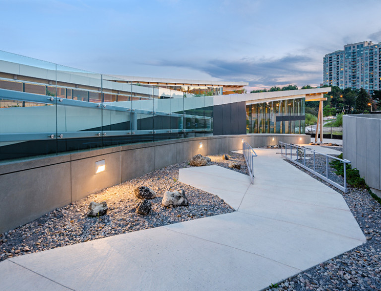 The outside walkway of the Scarborough Civic Centre Branch Library at dusk.