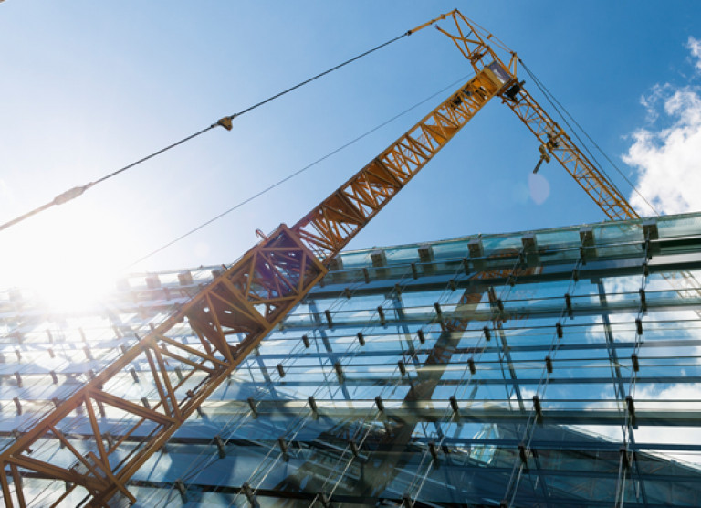 A crane on a construction site - design-build service.