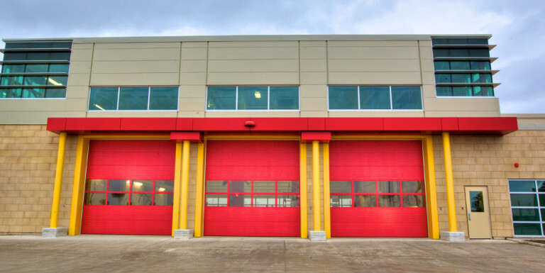 Three red garage doors of the Garry W. Morden Centre.
