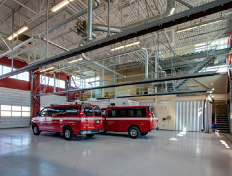The interior of the garage of the Garry W. Morden Centre holding two red cars.