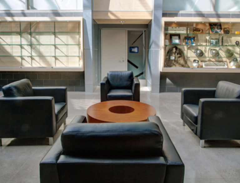 A group of black lounge chairs in the atrium hall of the Garry W. Morden Centre.