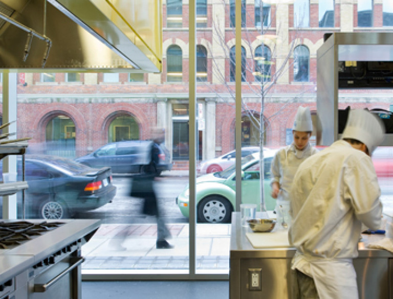 A view from the inside of the kitchen of the George Brown Culinary School through the windows.