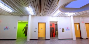 Shown is the hallway of the Bradford-West Gwillimbury Leisure Centre with focus on the lighted washrooms.