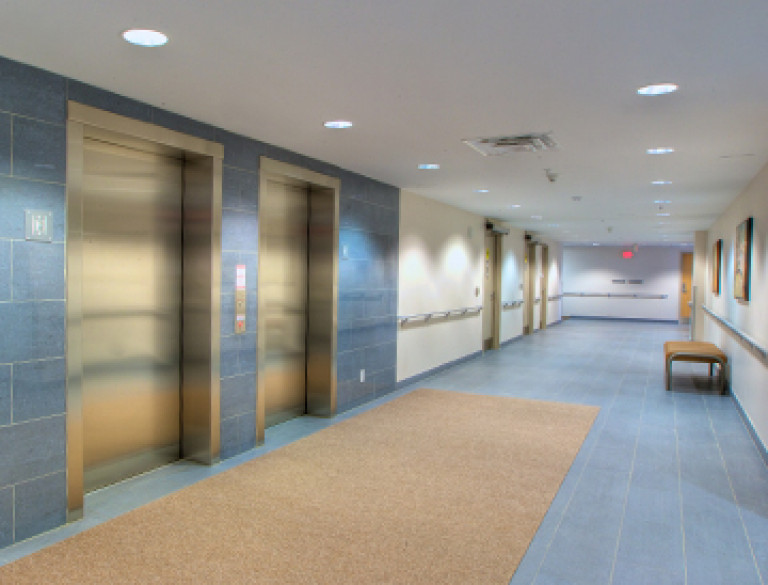 The hallway with elevators at the Mapleglen Residences.