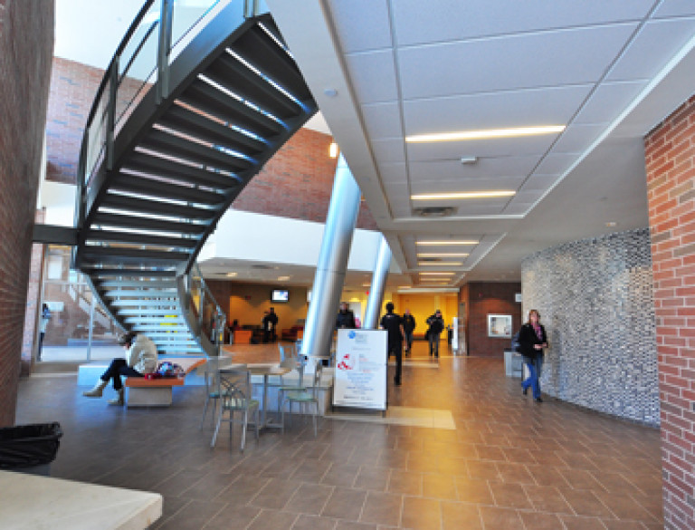 The hallway of the Niagara College - SAC with a flight of stairs.