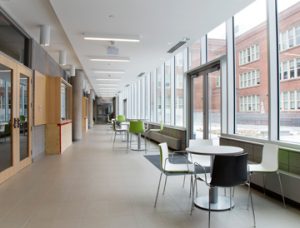 Shown is one of the bright corridors of the Regent Park Community Centre with seating.