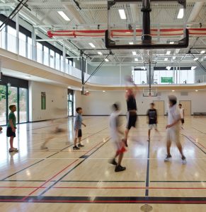 People playing a basketball game at the indoor court of the Stoney Creek Community Centre.
