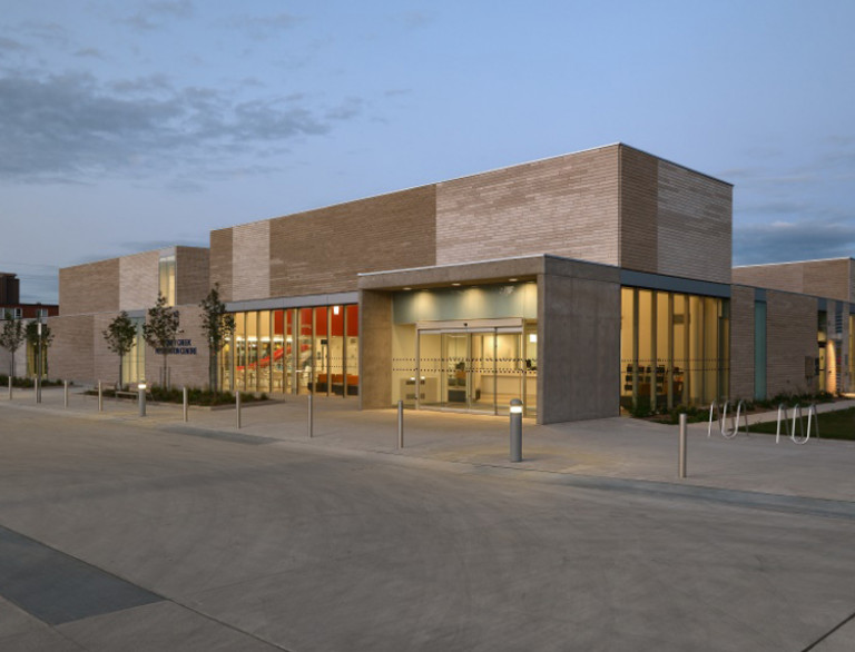 The facade of the Stoney Creek Community Centre at dusk.