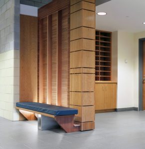 An interior shot of the W. Ross MacDonald School with focus on the mix of materials and bench.