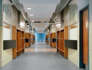 The corridor of the W. Ross MacDonald School and shelving.