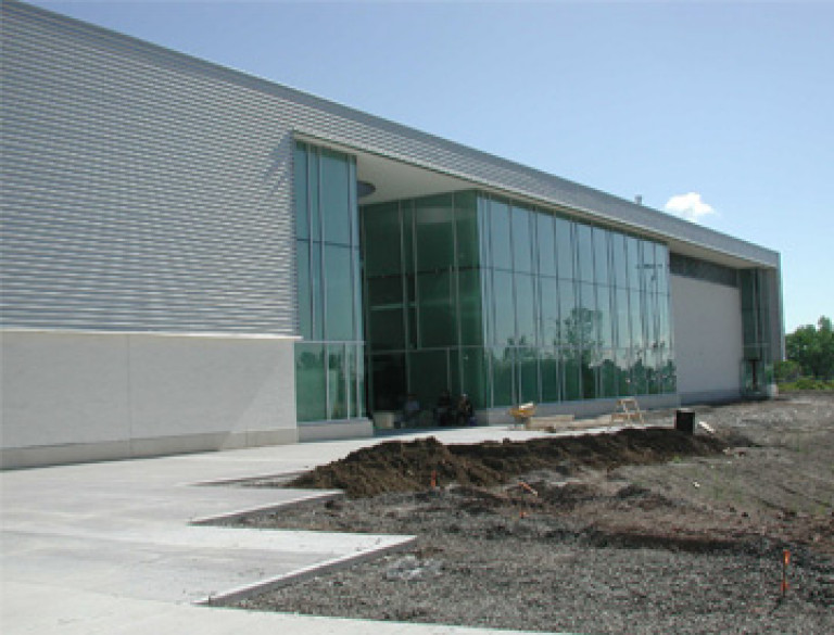 Exterior view of the MacBain Community Centre under landscaping construction.