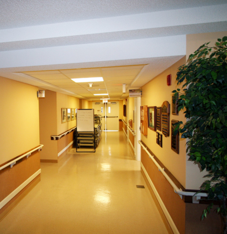 View of the length of a hallway within the Grove Park Long Term Care Facility.