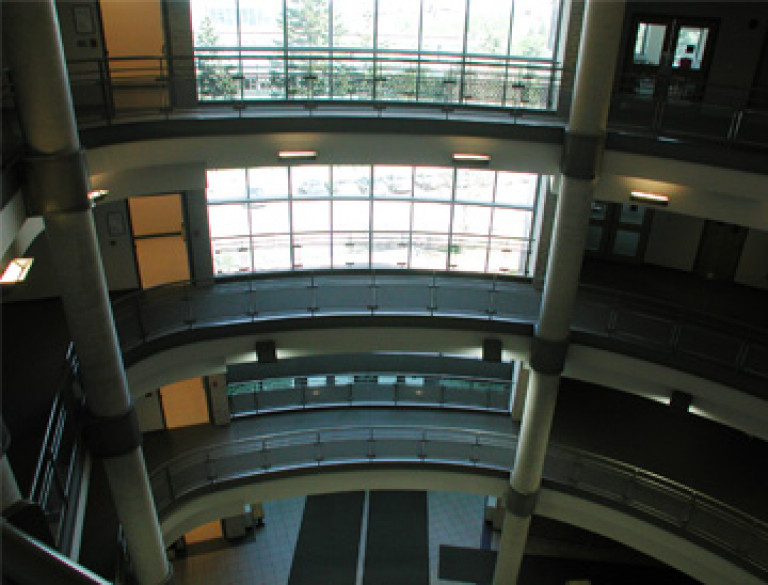 View of open space with high ceilings and natural light at the McMaster Institute for Applied Health Sciences.