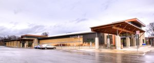 The Vic Johnston Community Centre's exterior combines stone, brick, and wood for stunning effect.