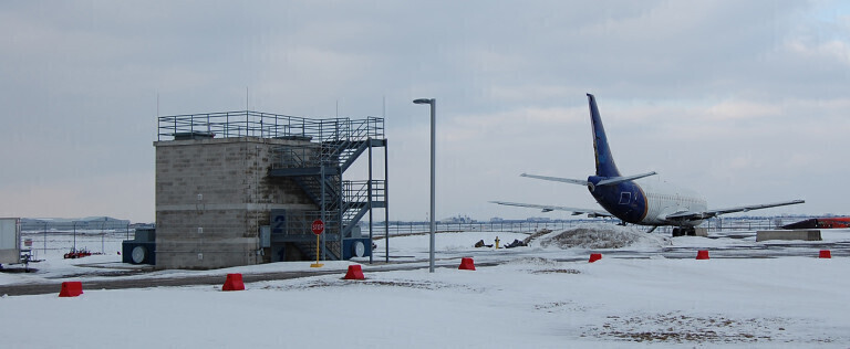Plane beside building on runway